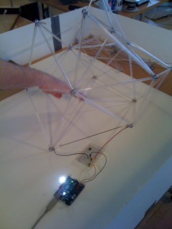02 - This polyhedron model is wired-up to an Arduino board. The board has a light which lights up in reaction to tension forces in a wire connecting two joints. 
