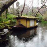 xx - A small traditional boat floats in the garden pond, designed to replicate a larger scale Japanese landscape. 