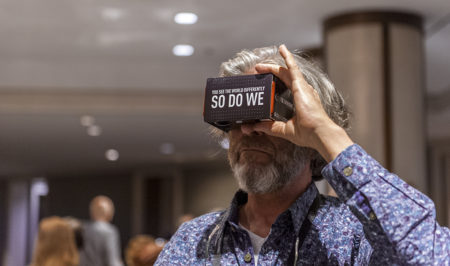 02 - An attendee trying on the VR cardboard headset to view the new Virtual Reality technology in future Vectorworks products. 